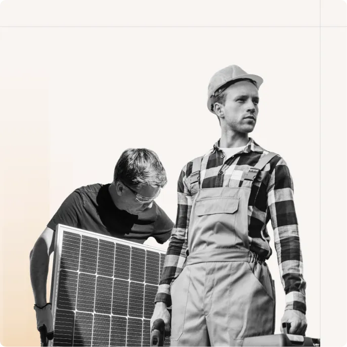 Workers carrying solar panels